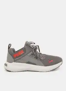 Grey Puma athletic sneakers with red logo and white sole for men and women.