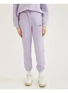 Relaxed fit lilac knitted joggers with elastic cuffs and drawstring waist.