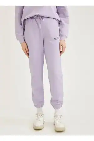 Relaxed fit lilac knitted joggers with elastic cuffs and drawstring waist.