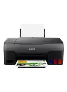 Canon inkjet printer printing colorful photo with ink cartridges visible.
